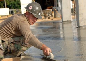 Man smoothing concrete with a trowel in High Point, North Carolina